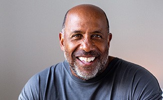 Closeup of senior man in gray shirt smiling