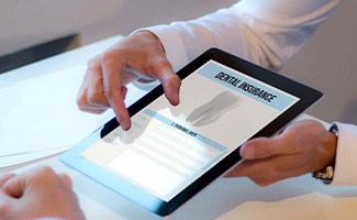 Patient reviewing dental insurance form on tablet