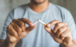 Closeup of patient breaking cigarette