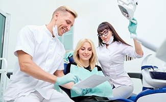 Dentist discussing treatment with female patient