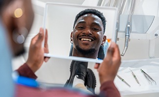 Young male patient smiling at the dentist’s office