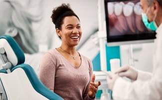 Patient smiling at dentist during consultation