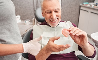 Dentist discussing dentures with male patient
