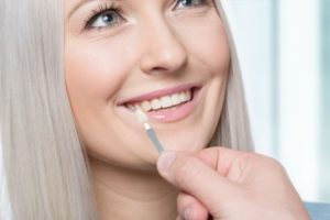 a patient smiling while receiving veneers