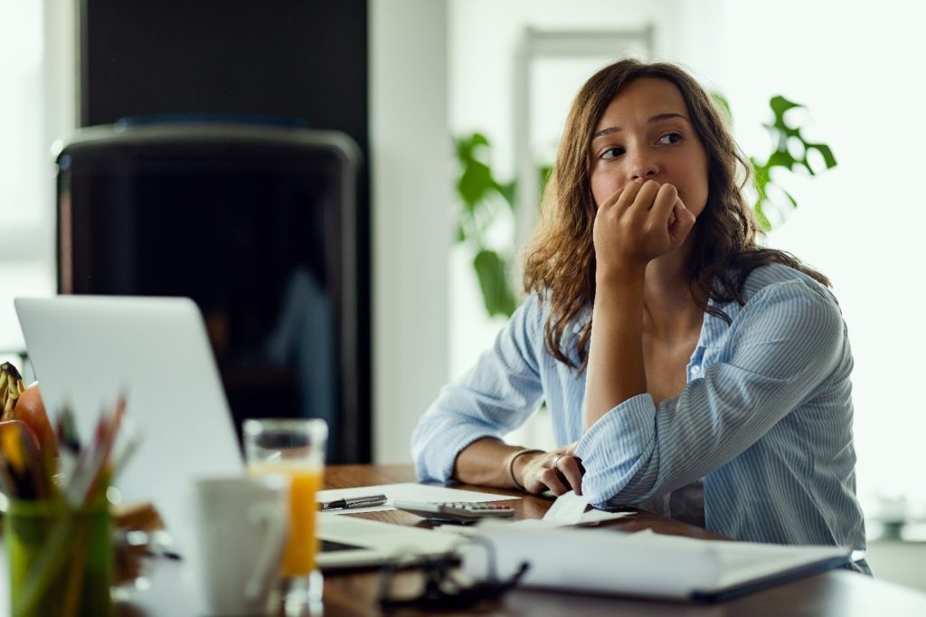 Woman looking worried while working at home