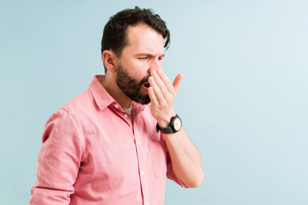 Man checking how his breath smells